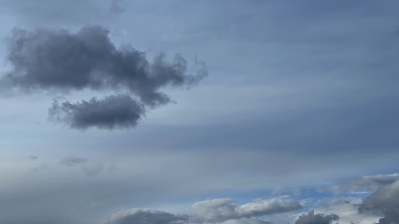 Little clouds transform in the overcast sky. Rainy cloudscape formation in the atmosphere