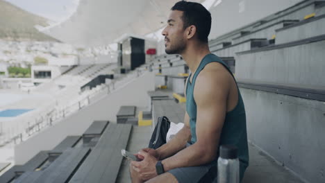 man relaxing on stadium bleachers