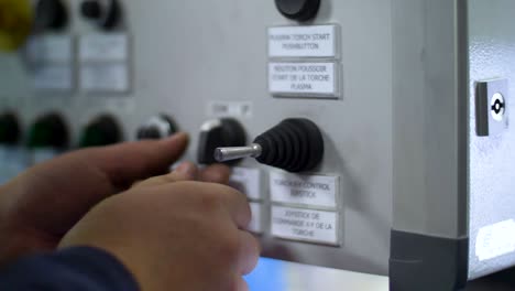 man operates a control panel at the factory