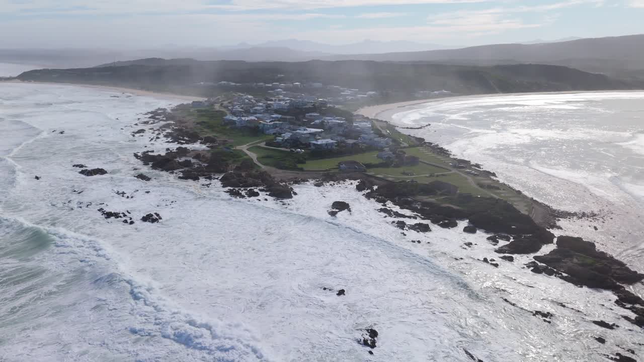 Drone Orbit Around Misty Buffalo Bay Coastline in South Africa with Ocean Views