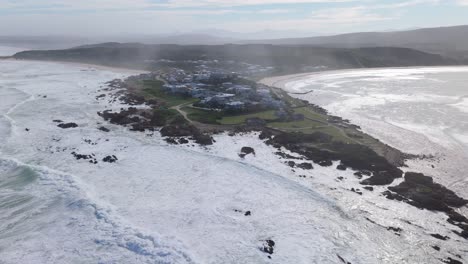 drone orbit around misty buffalo bay coastline in south africa with ocean views