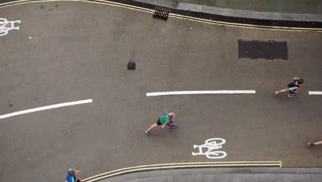 slow motion birds eye view of runners on street