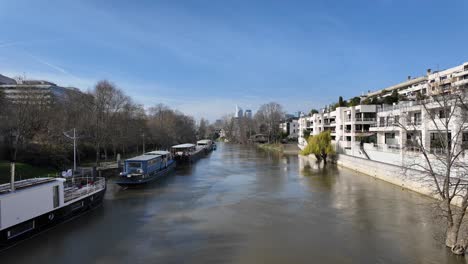 boats moored along river at neuilly-sur-seine, france