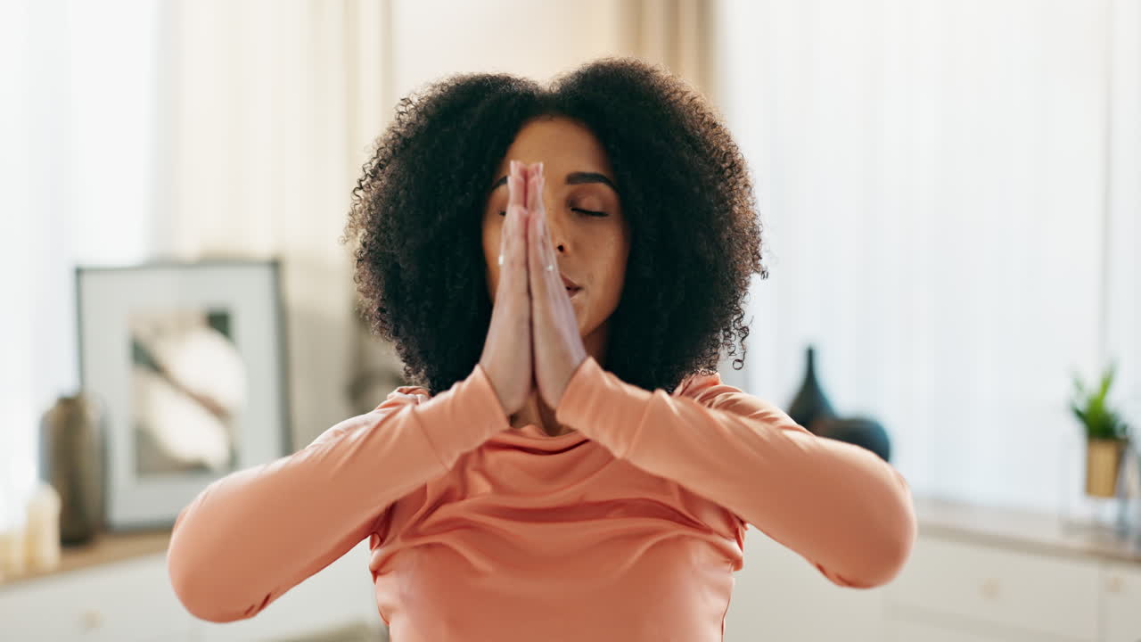 Woman practicing yoga and meditation at home