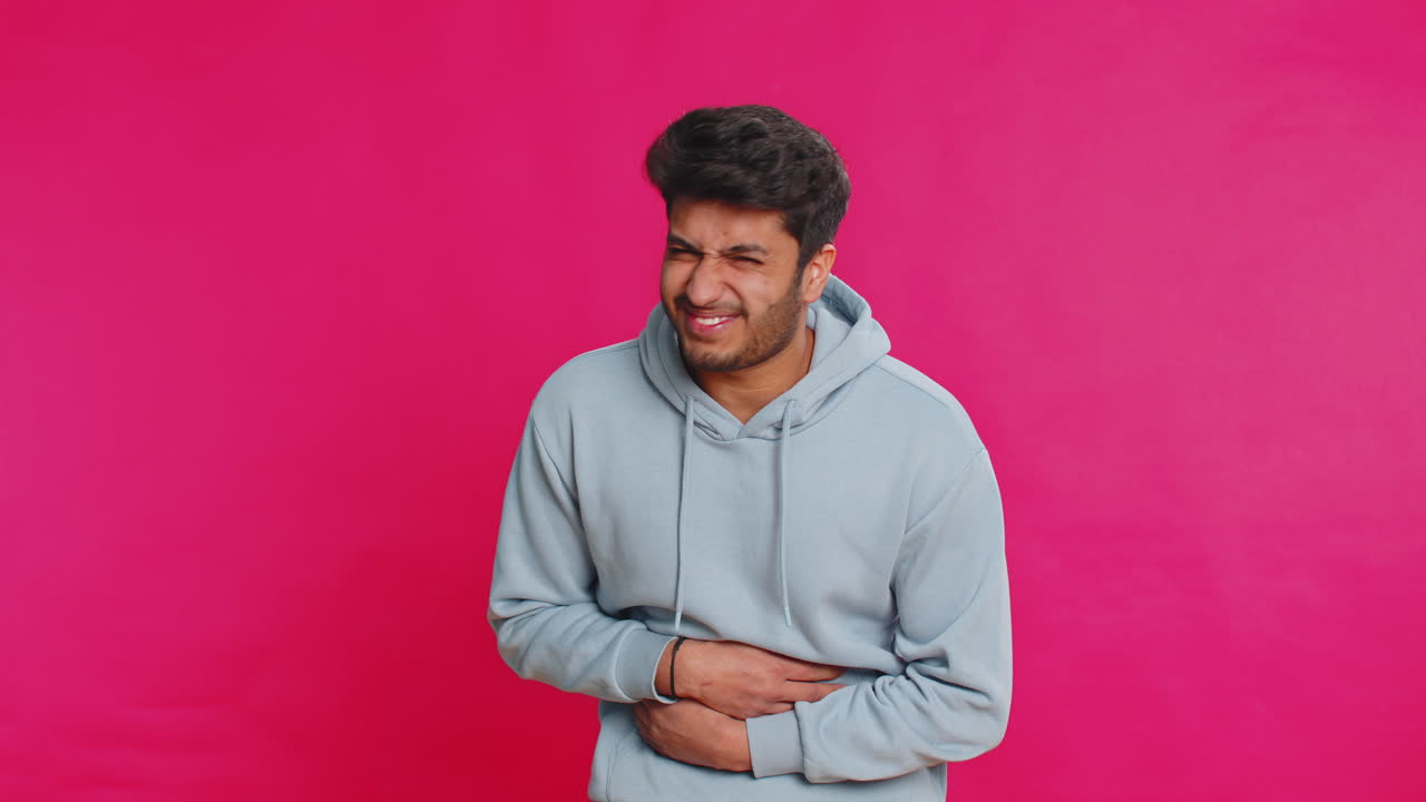 Indian man feeling sudden strong abdominal stomach ache gastritis problem diarrhea poisoning