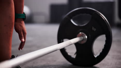 man lifting barbell in gym