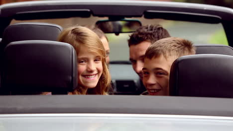 family in a silver car