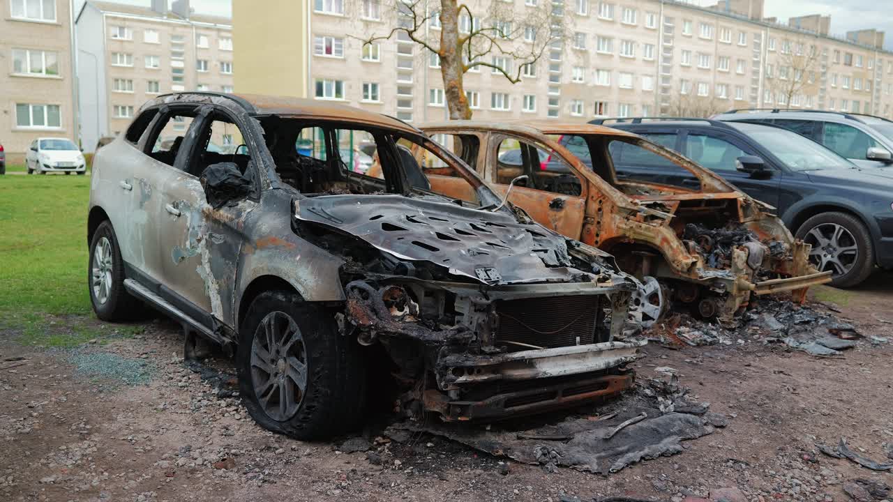 Burned cars in residential area of Liepāja Latvia, charred after spring arson