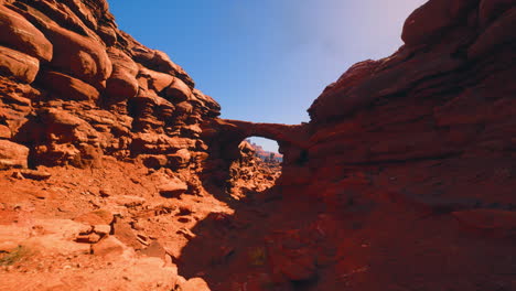 red rock arch in a canyon