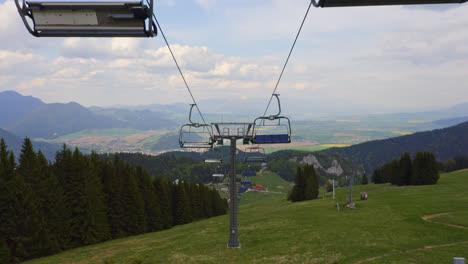 empty chair lifts travelling along the mountainside in malino brdo located in ružomberok, liptov, slovakia