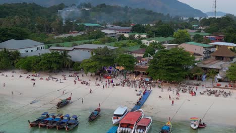 sun setting over a stunning thai beach, tourists soaking in the view