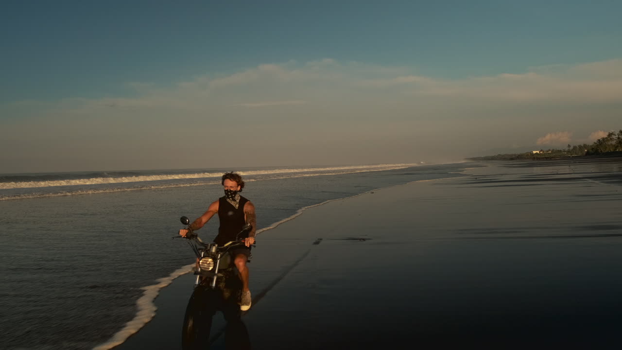 Motorcycle Ride on a Tropical Beach at Sunset