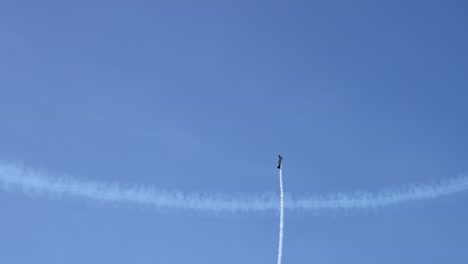 aircraft performing stunts over crowded beach