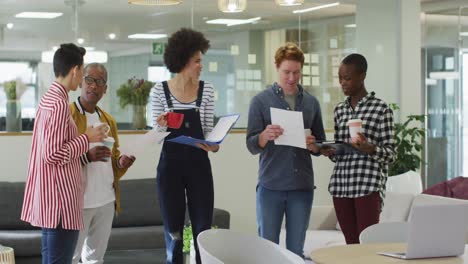 Diverse-male-and-female-business-colleagues-discussing-at-meeting-in-office