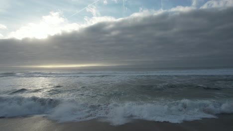 strong ocean waves crashing on the beach