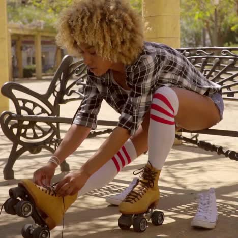 woman prepares for roller skating outdoors