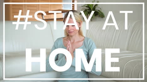 caucasian woman practicing yoga at home during coronavirus pandemic with words stay home