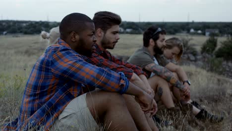 diverse people taking rest in nature and chatting