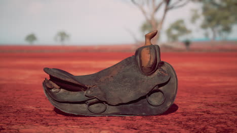 old decorated mexican saddle lying on sand