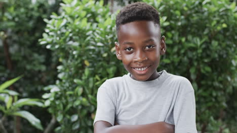 african american boy smiles confidently outdoors