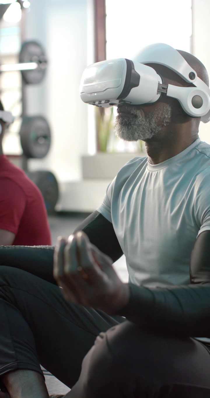 Vertical video: Starting VR meditation, African American friends meditating at gym, copy space