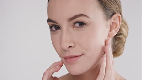 beauty portrait of woman touching beautiful face slow motion skincare concept on a grey background slow motion red epic dragon