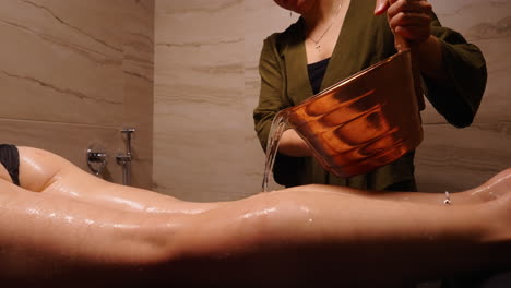 woman receiving water therapy massage in a spa