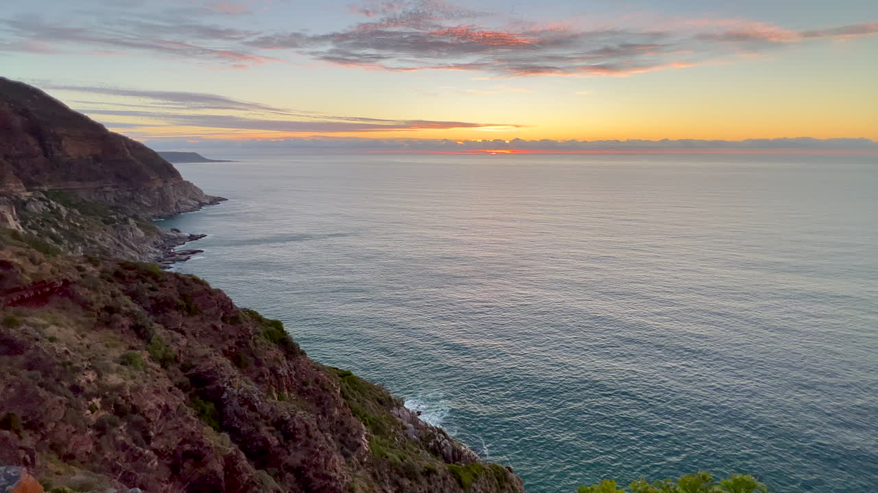 Chapman Peak Drive sunrise sunset Noordhoek Hout Bay Marina scenic Table Mountain epic travel road coastline cliffside view Cape of Good Hope South Africa lush spring summer cinematic pan left slowly