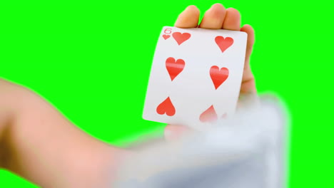 hand shuffling and pushing cards towards camera