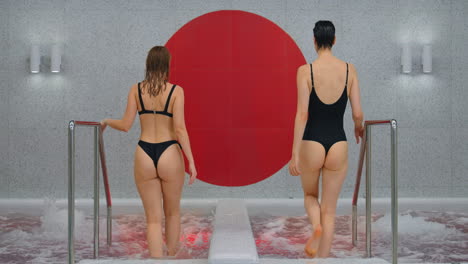 two women relaxing in a modern spa hot tub