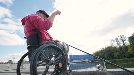 person with a physical disability who uses wheelchair fishing from fishing pier