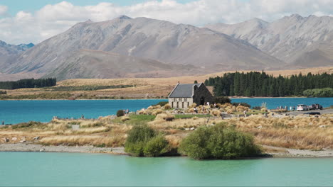 Tourists-exploring-iconic-Church-of-the-Good-Shepherd,-on-the-shores-of-Lake-Tekapo-in-New-Zealand