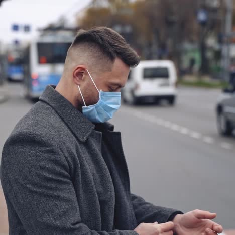 man in protective medical wear looking to the camera walking in the city. responsible behavior during world covid-19 pandemic