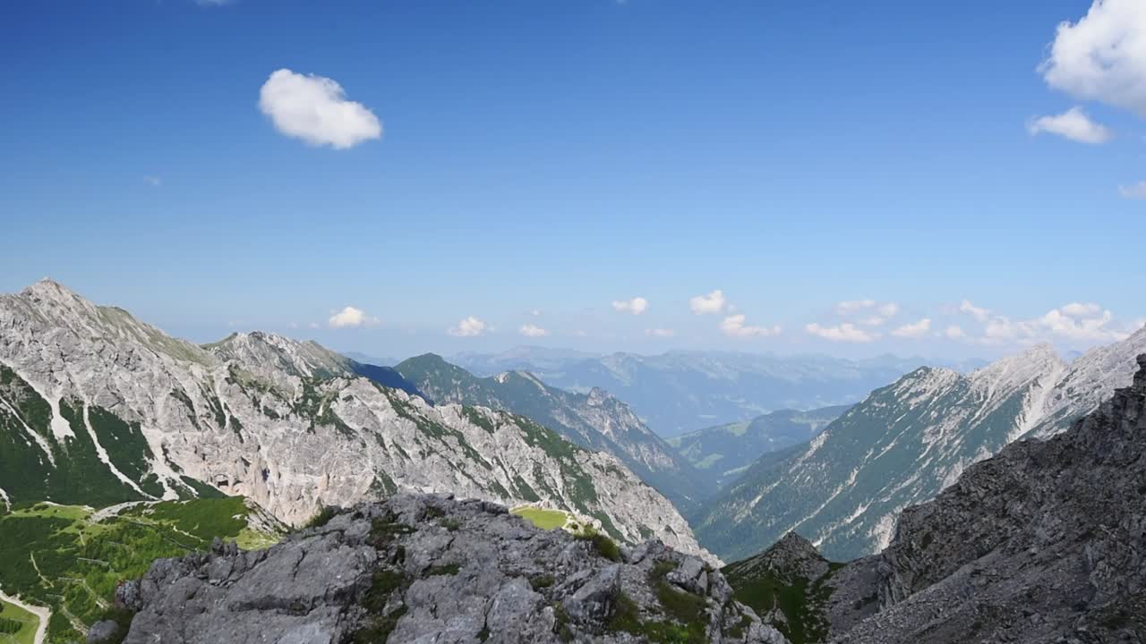 Panoramic view of a mountain top in the alps at Liechtenstein near Schesaplana. Pan left showing white rugged mountains