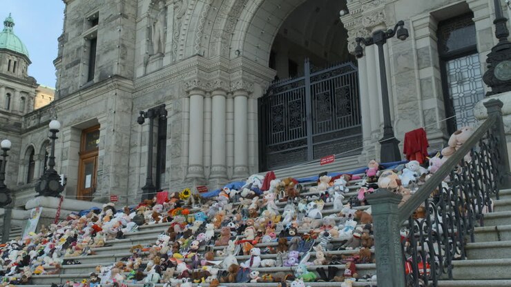 Shot of the BC Legislative Assembly buildings with a memorial for Indigenous Children victims on the front steps in Victoria BC