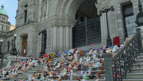 shot of the bc legislative assembly buildings with a memorial for indigenous children victims on the front steps in victoria bc