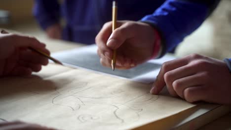 artisans team working together on artistic project using pencil leads and paper