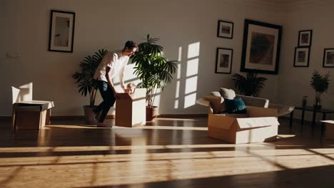 father and son playing with moving boxes