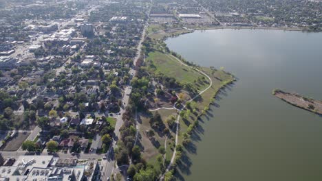 a 4k high-flying drone shot of sloan’s lake, the biggest lake in the city of denver, colorado, and home to the second largest park in the city, and a myriad of outdoor activities