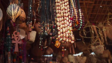 egyptian bazaar souvenir shop, close up of beads and necklaces moving in the wind