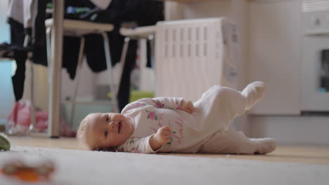 una niña adorable acostada de lado en la alfombra