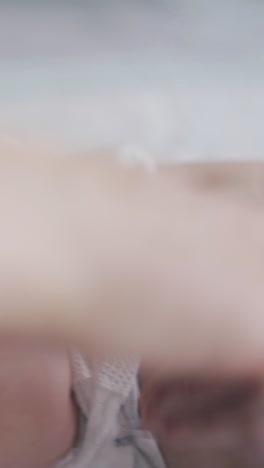 skilled pediatrician performs infant legs massage on lying on changing table adorable baby boy extreme close view