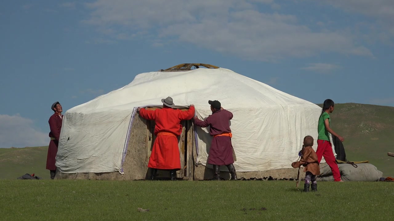 Mongolian Family Assembling a Traditional Ger Tent on the Steppe