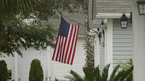 house with american flag waving in slow motion