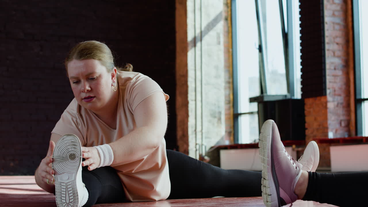 Woman stretching indoors