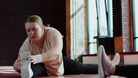 woman stretching indoors