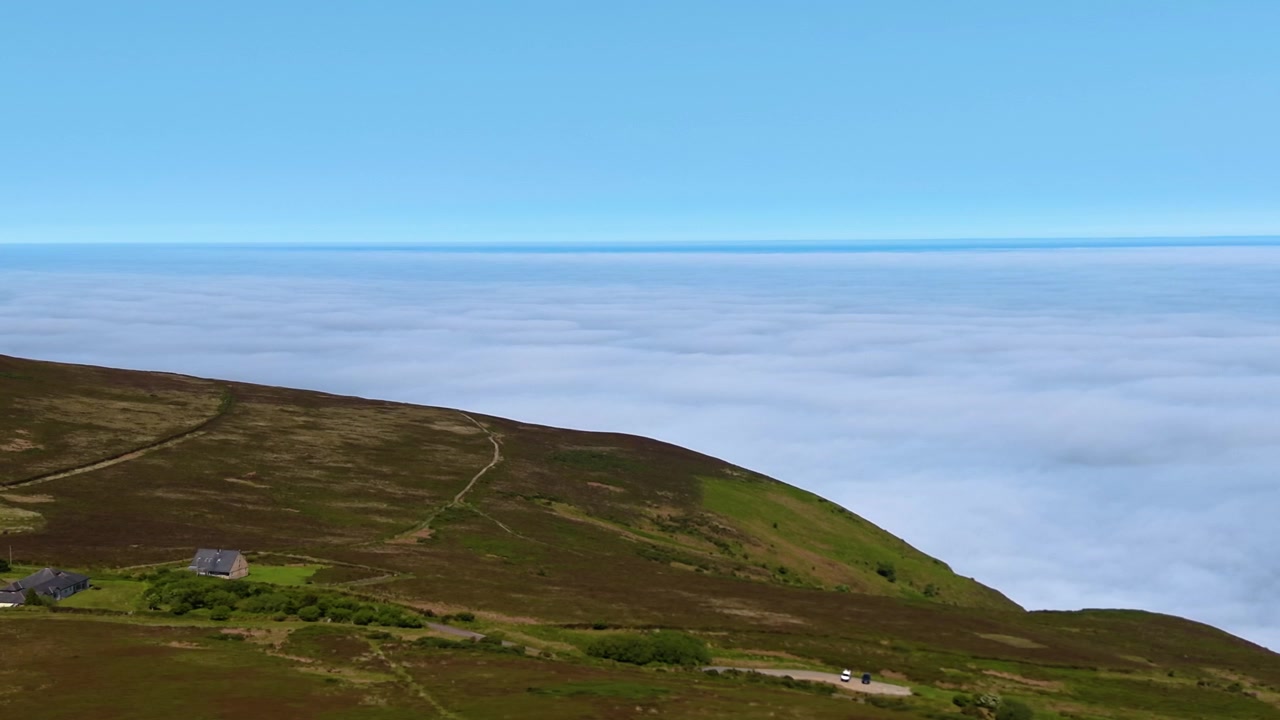 Thick Dense Clouds Over the Ocean near High Coastal Cliffs. Cloud Inversion Caused by Layer of Warmer Air Overlying Cooler Air. Drone Clip in North Devon, UK. 4K.