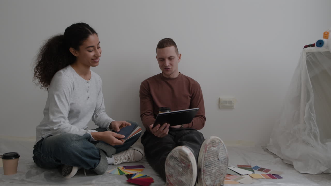 Young Couple Choosing Paint Colors for Home Renovation