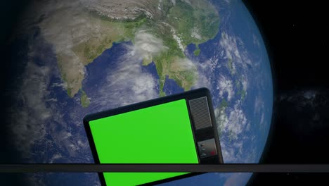iron hatch opens panoramic view to the television set in the space. television set scanning and monitoring the earth from space. the tv with green screen orbiting the earth planet.
