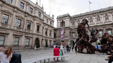 people observing a large outdoor sculpture